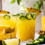 Refreshing and delicious pineapple margarita with a little kick of heat! This fun cocktail is perfect for sipping on a warm, sunny day, and is only lightly sweetened with pineapple juice. Add your desired level of spice by adding more or less jalapeño slices, or omit them if spicy isn't your thing. The cocktail will still taste great!