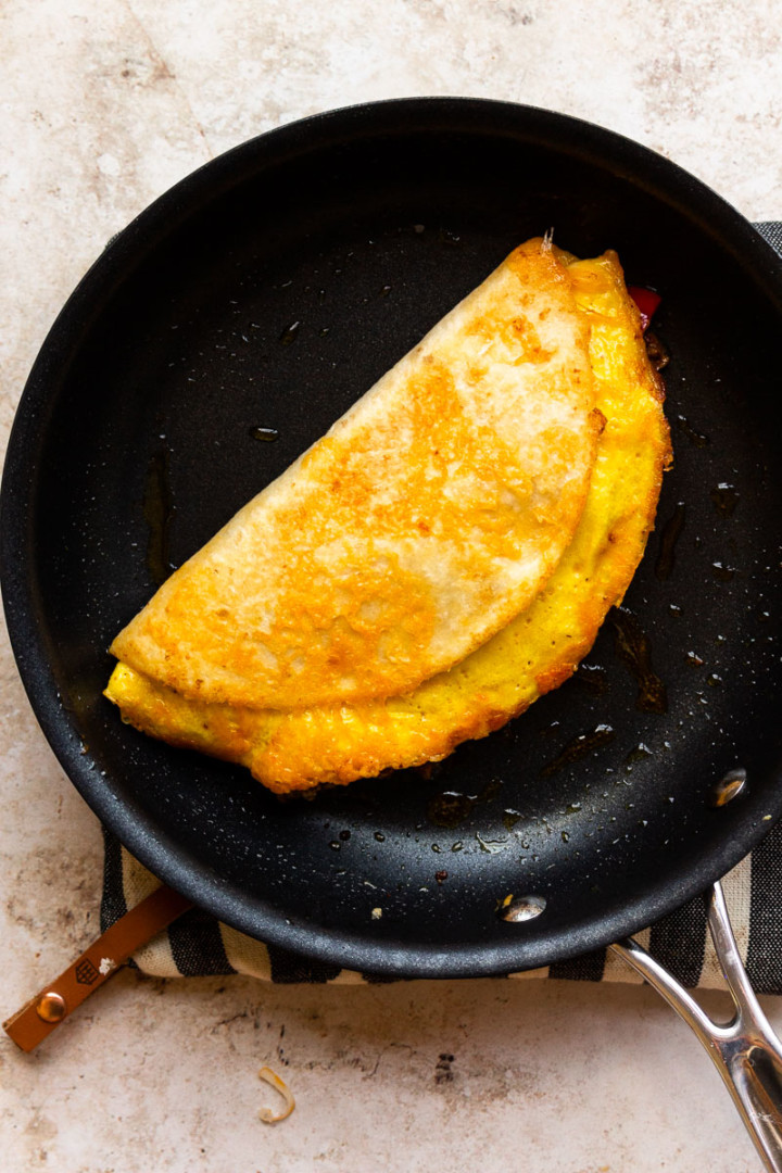 quesadilla breakfast taco frying in a pan