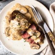 venison steak covered in mushroom cream sauce