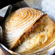 cooked sourdough loaf in a dutch oven fresh out of the oven