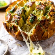 pulling apart cheesy garlic bread