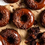 brownie donuts aka bronuts dipped in chocolate ganache and top with chocolate sprinkles