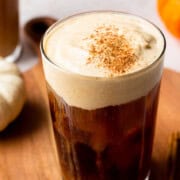 pumpkin cold foam over cold brew in a glass