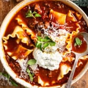 lasagna soup in a bowl topped with whipped pesto cottage cheese