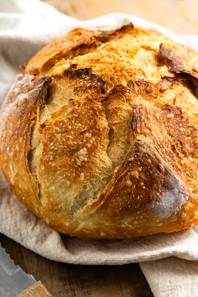 loaf of baked bread on a kitchen towel