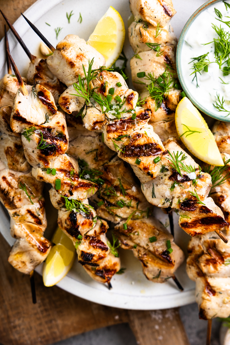 chicken skewers garnished with fresh dill and chives