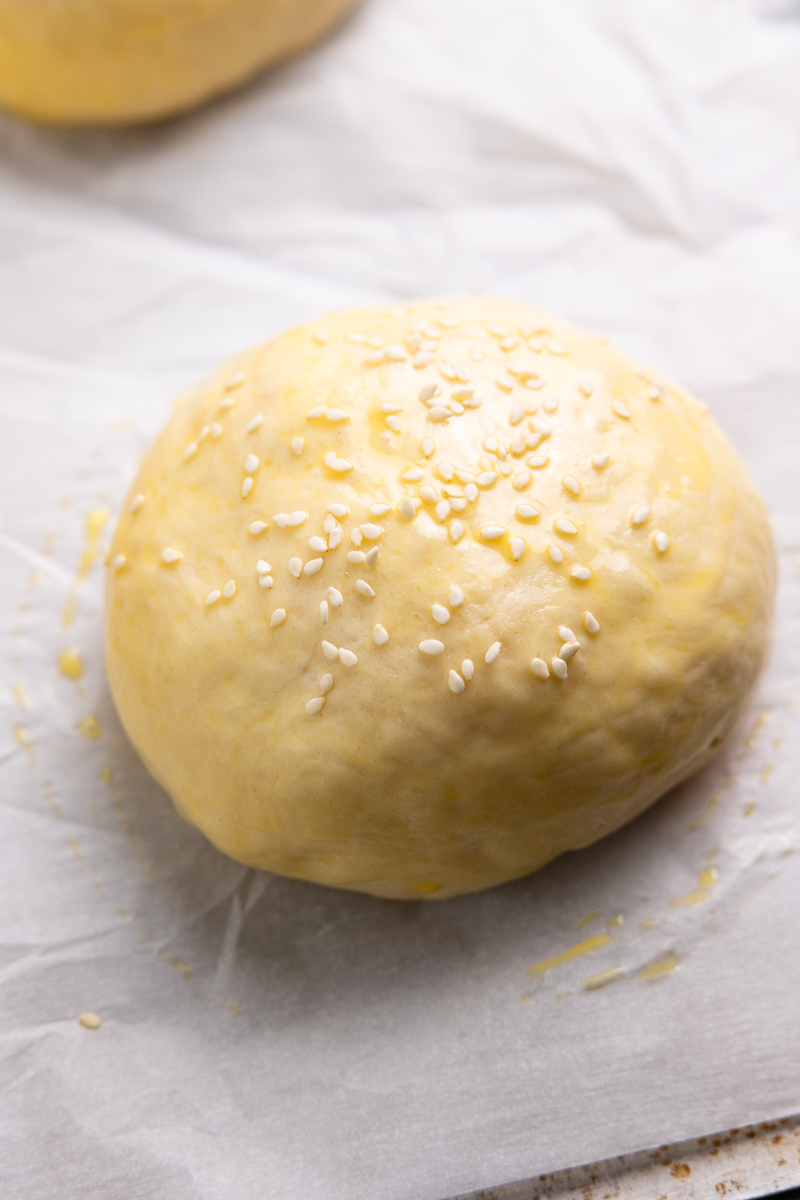 Dough ball brushed with egg wash and sprinkled with sesame seeds
