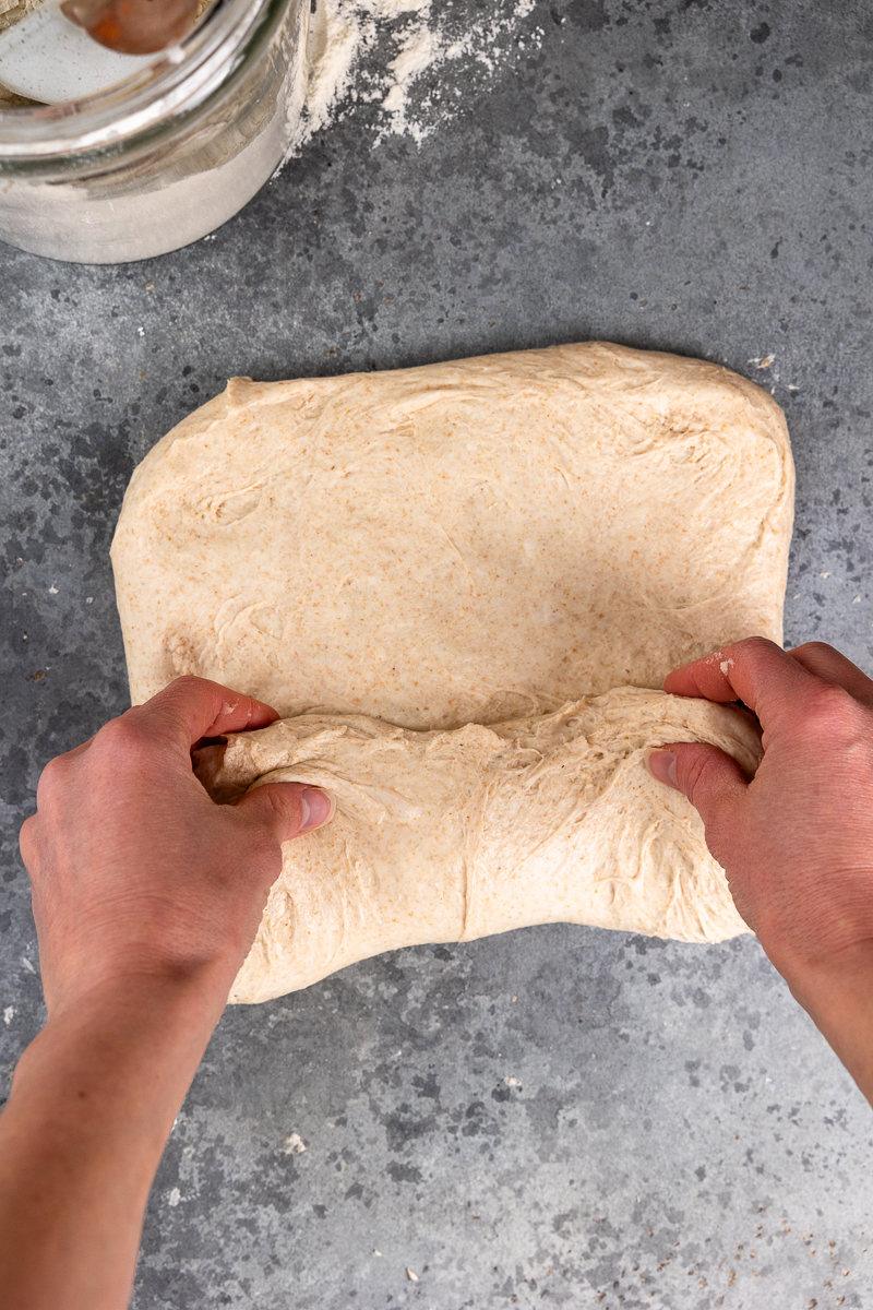 shaping the dough by folding up the bottom half