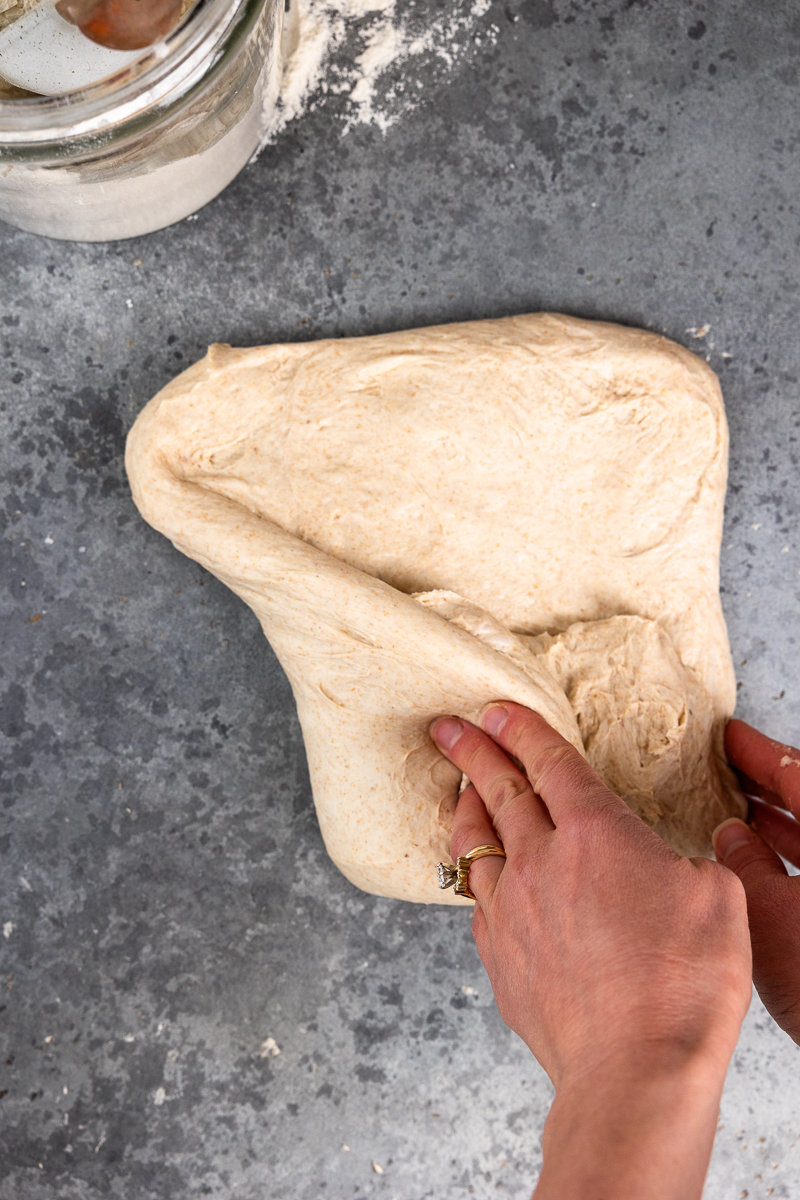 Folding over the bottom left of the dough