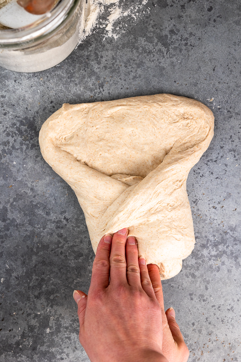 Folding over the bottom right of the dough