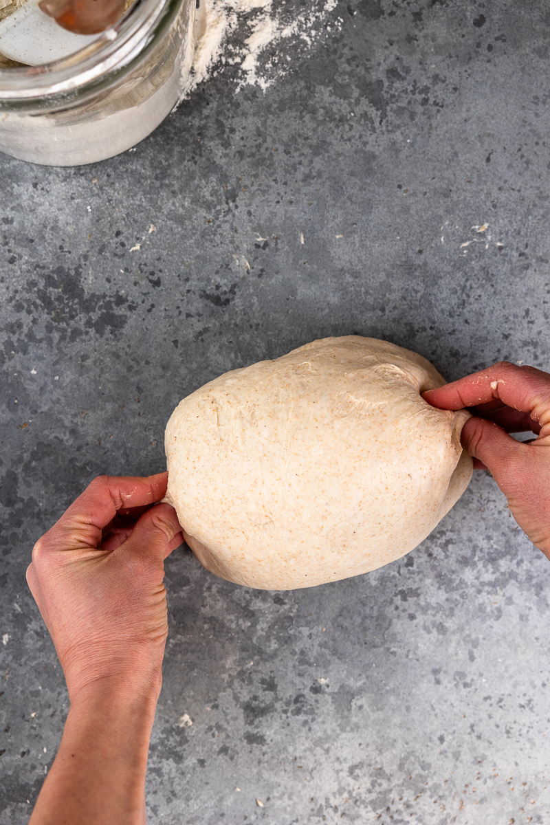 pinching the ends of the dough ball