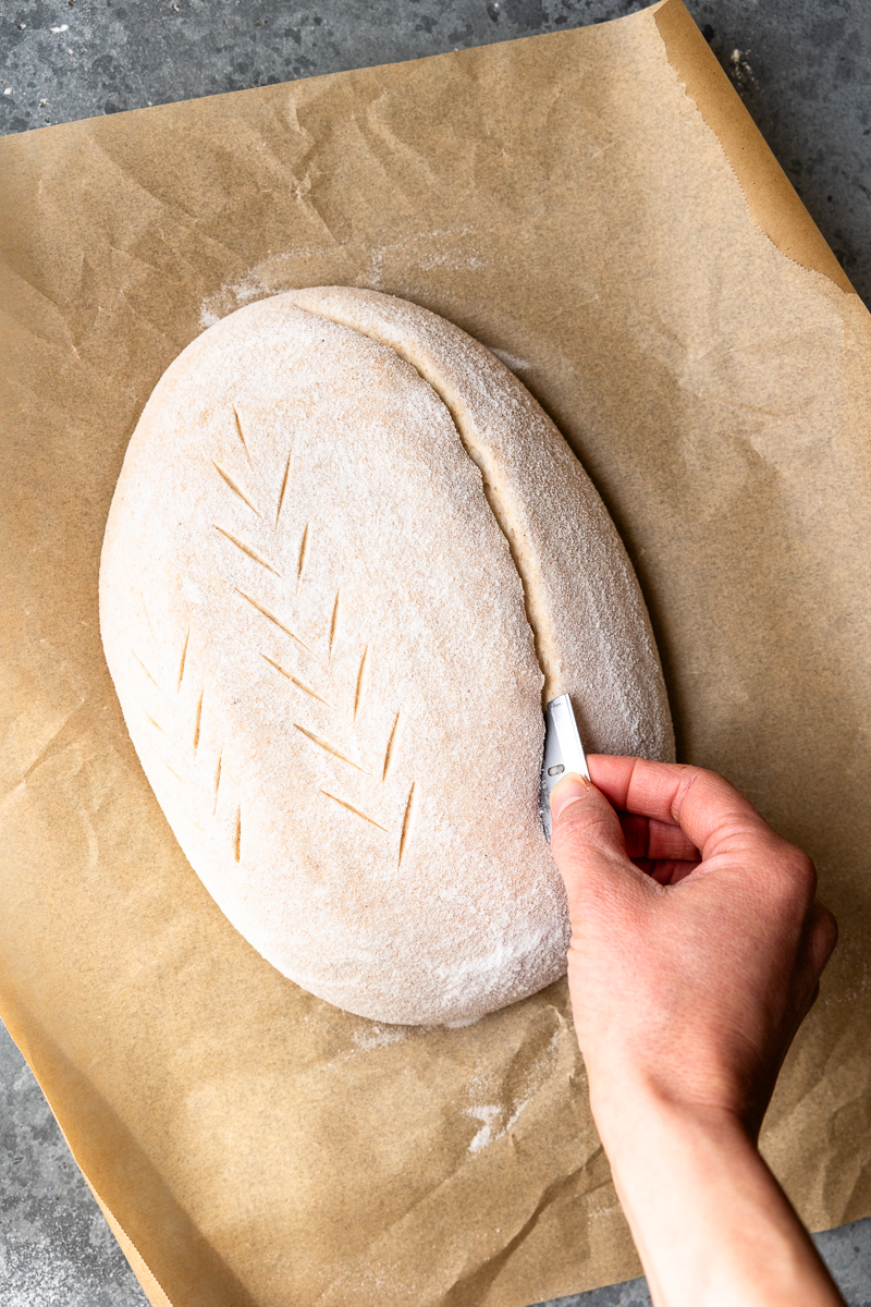 scoring the dough with a razor