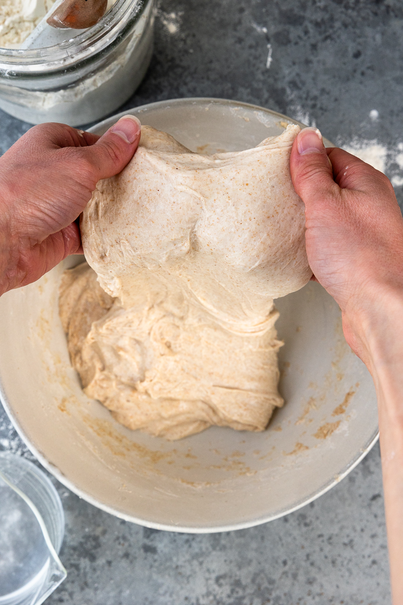 stretching the dough up using your hands