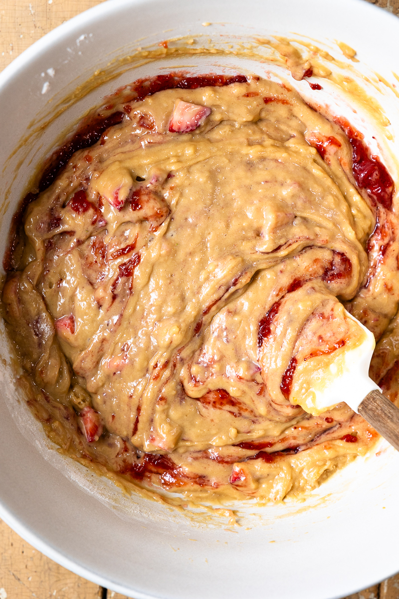 mixing bread batter in a bowl with a spatula