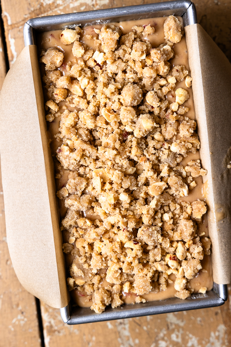 bread batter in a loaf pan and topped with streusel