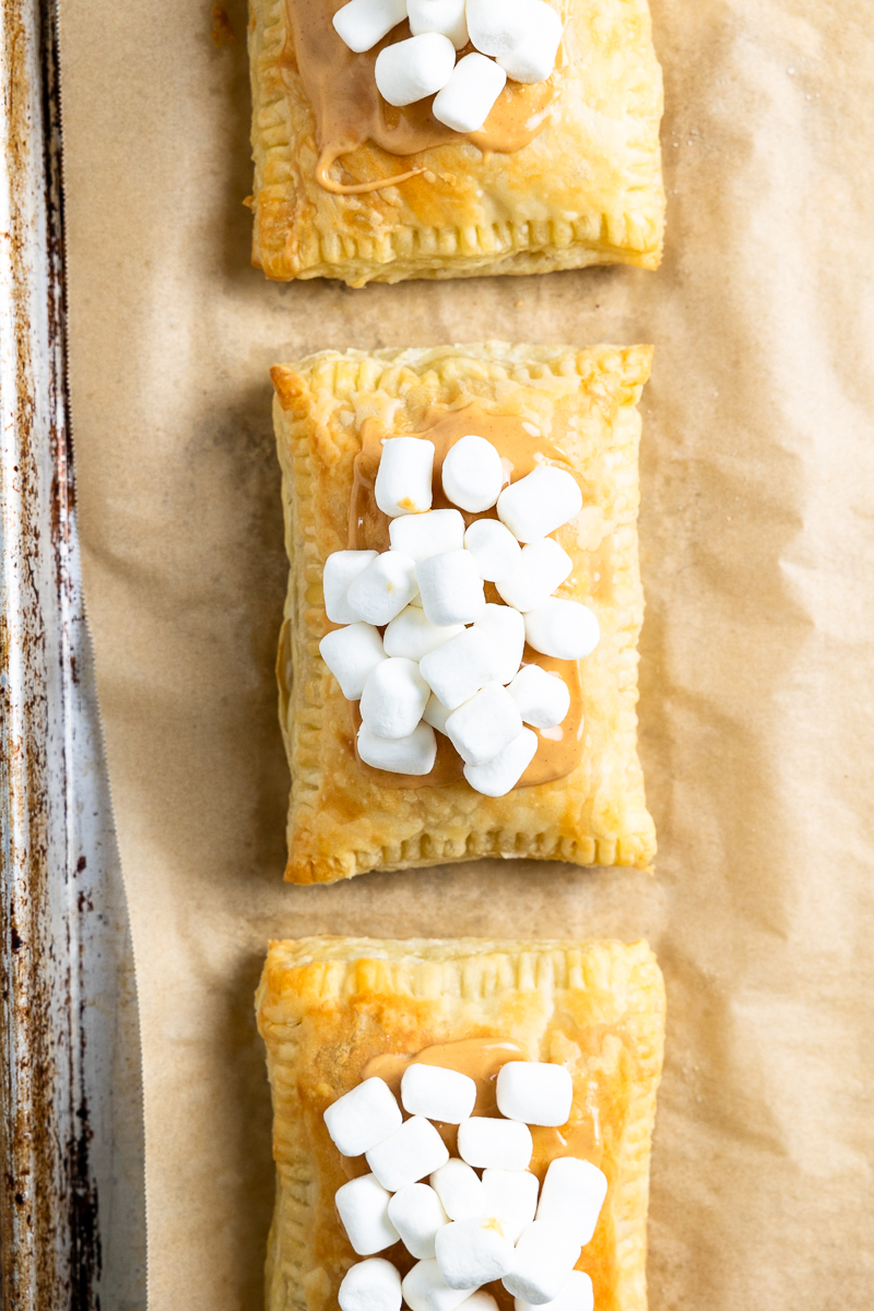 Baked pastries topped with peanut butter and mini marshmallows