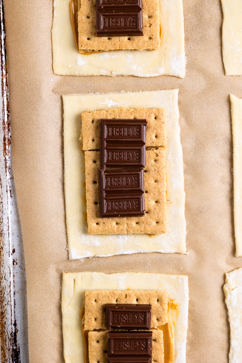 pastry spread with peanut butter then topped with graham crackers and chocolate