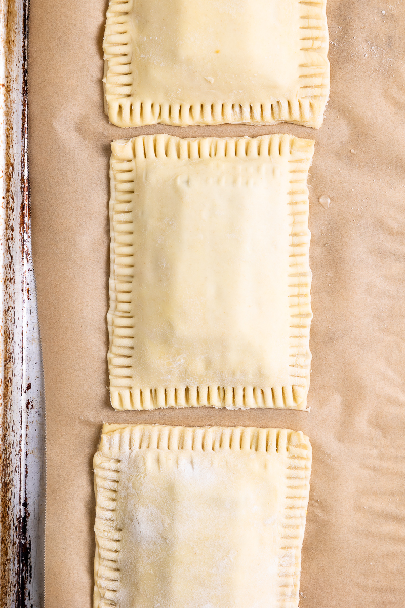 additional pastry placed on top and sealed closed by crimping the edges with a fork